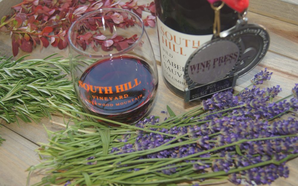 Award winning bottle of South Hill Cabernet Sauvignon with freshly picked lavender and herbs